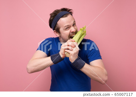 portrait of a man with celery on white background portrait of a man with celery on white background 65007117