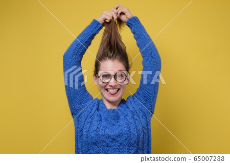 Attractive caucasian woman holding to the hair 65007288