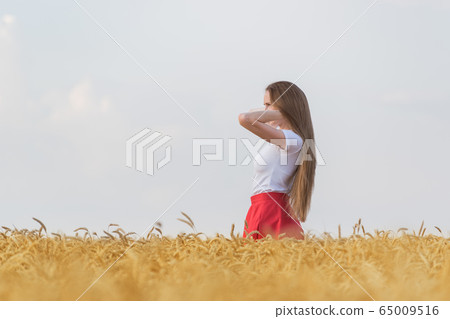 Pretty young woman with long beautiful hair 65009516