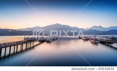 Sun Moon Lake at sunrise in Nantou, Taiwan. Sun Moon Lake at sunrise in Nantou, Taiwan. 65010630