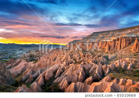 Beautiful mountains and Red valley  at sunset in Goreme, Cappadocia in Turkey. 65010669