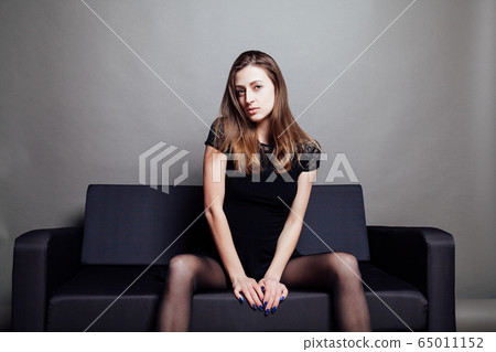 beautiful girl in black dress lays on the couch beautiful girl in black dress lays on the couch 65011152