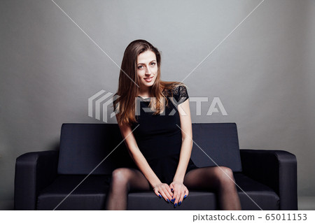 beautiful girl in black dress lays on the couch beautiful girl in black dress lays on the couch 65011153