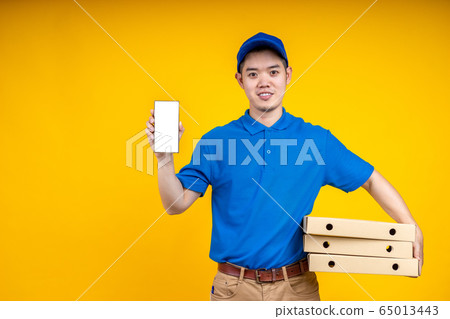 Young Asian delivery man holding food or pizza box Young Asian delivery man holding food or pizza box 65013443