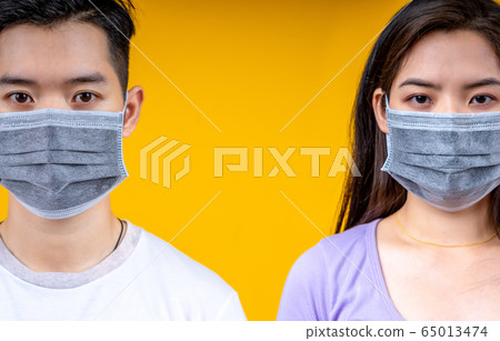 Young asian man and woman wearing medical mask on 65013474