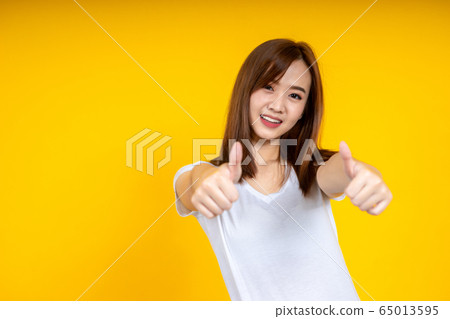 Close up of young Asian woman isolated on yellow Close up of young Asian woman isolated on yellow 65013595