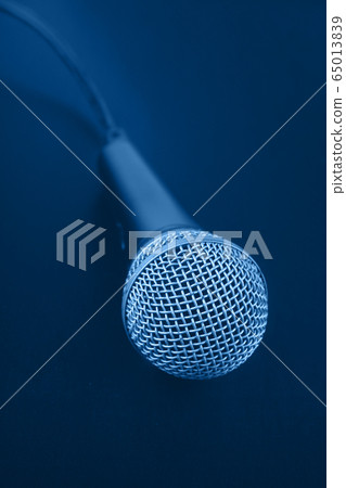 Close up classic microphone with cable over dark 65013839
