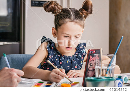 Cute pretty girl draws with pencils and paints. Cute pretty girl draws with pencils and paints. 65014252