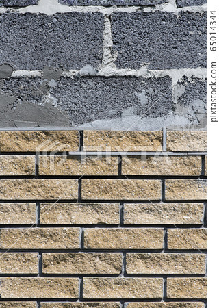 Wall cladding with decorative bricks, front view. Material for decorating the wall of house or fence 65014344