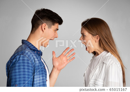 Millennial boyfriend and girlfriend swear and scream. Millennial boyfriend and girlfriend swear and scream. 65015167