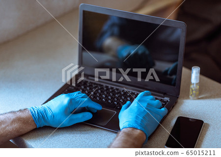Male Hands In Gloves On Laptop, Man Working From Home 65015211