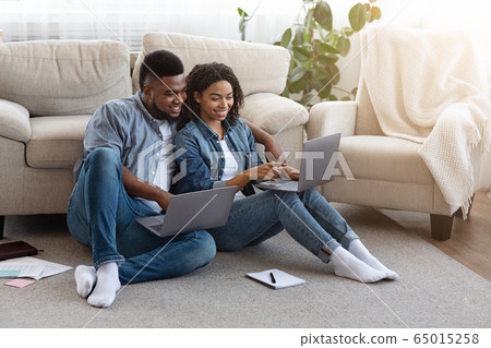Remote Work. Black Couple Using Laptops At Home, Working Online Together 65015258