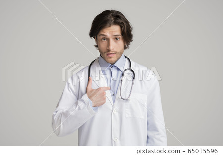 Puzzled male therapist pointing at himself with questionnaire face expression Puzzled male therapist pointing at himself with questionnaire face expression 65015596