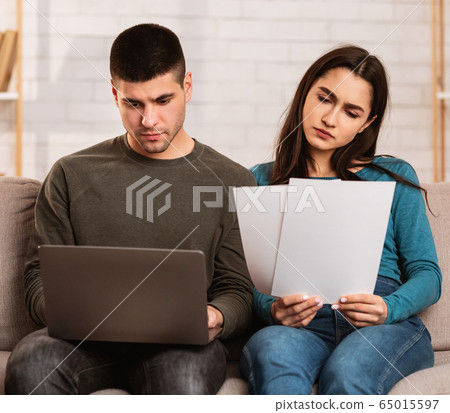 Couple having financial problems, managing family budget Couple having financial problems, managing family budget 65015597