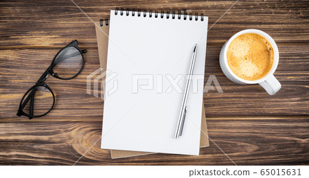 Notebook with pen, glasses and coffee. Notebook with pen, glasses and coffee. 65015631