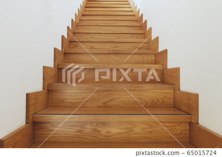 Wooden staircase and white walls bottom view Wooden staircase and white walls bottom view 65015724
