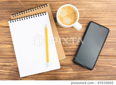 Notebook with pencil, smartphone, and coffee cup. 65016608