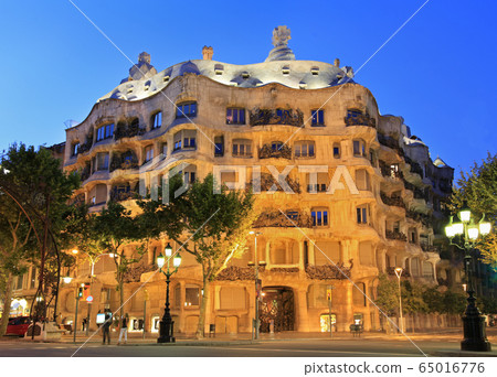 La Pedrera or Casa Mila at dusk, built during the years 1905-1910 and designed by Antoni Gaudi, Barcelona, Spain 65016776