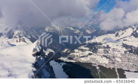 Fantastically beautiful snow landscape in the mountains - aerial flight footage 65016840