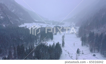 Wonderful snowy winter landscape in the Alps - aerial view Wonderful snowy winter landscape in the Alps - aerial view 65016842