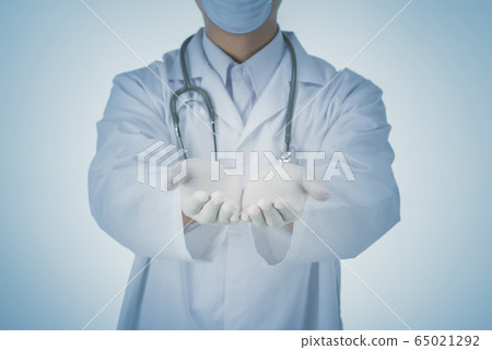 Doctor presenting blank palm of hand Doctor presenting blank palm of hand 65021292