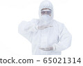 Doctor with protective clothing presenting blank palm of her hand 65021314