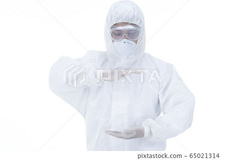 Doctor with protective clothing presenting blank palm of her hand 65021314