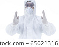 Doctor with protective clothing presenting blank palm of her hand 65021316