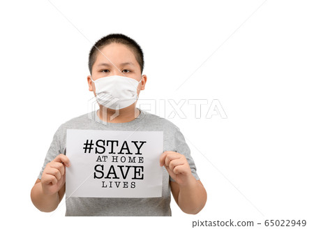 Child wear mask shows a paper with stay at home 65022949