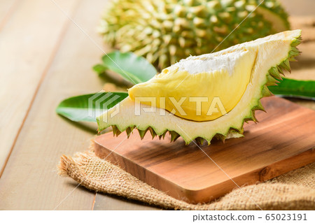 Fresh cut durian (monthong) on sack and old wood 65023191