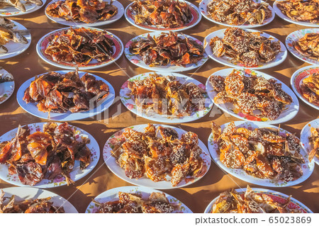 Many kinds of deep fried fish on dish for sale at street food in Thailand. 65023869