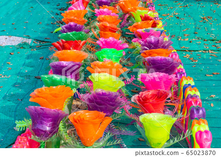 Recycled colorful plastic flowers made from plastic bottles to decorate as flowers in the garden. Plastic bottle recycled. 65023870