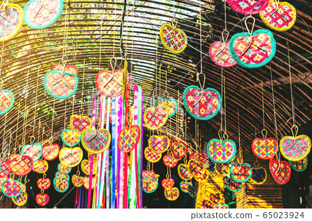 Many colorful of fanning woven from bamboo are hung above to decorate the walkway in the annual happiness festival in public park. Selective focus. 65023924
