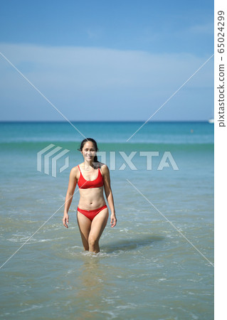 Asian Chinese Woman in various yoga poses at the 65024299
