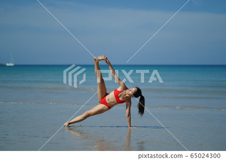 Asian Chinese Woman in various yoga poses at the 65024300