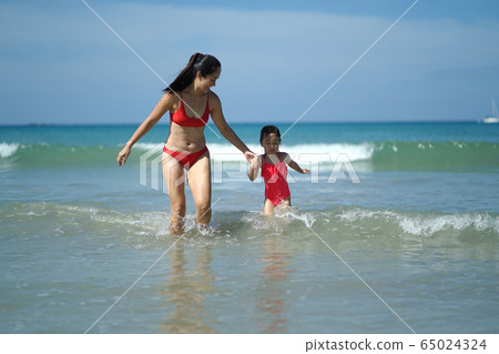 Asian chinese woman spending time playing with daughter 65024324