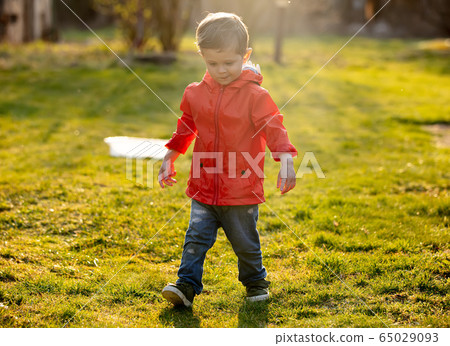 Funny toddler boy with wet hands at outdoor Funny toddler boy with wet hands at outdoor 65029093