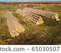 Rolls of haystacks on the field as agriculture harvest concept. 65030507