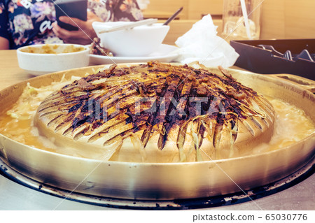 Close up to soot on brass barbecue grill after use in the restaurant. Close up to soot on brass barbecue grill after use in the restaurant. 65030776