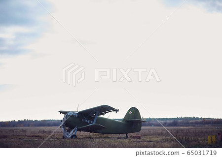 Old working plane on the field, daytime Old working plane on the field, daytime 65031719