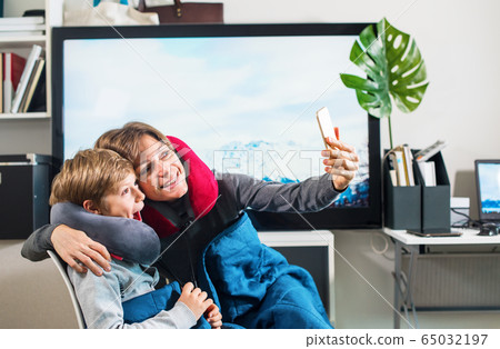 happy boy with mom imitating flight in airplane 65032197