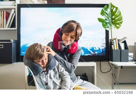 Mom taking care son imitating flight in airplane 65032198