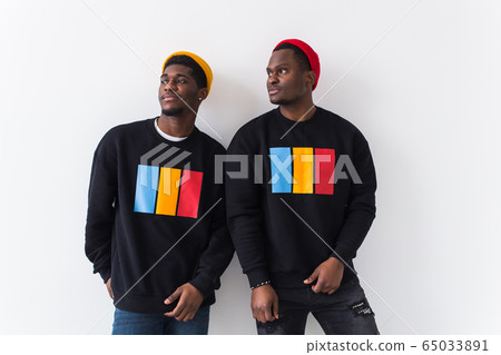Street fashion and friendship concept - Two happy african american young men in black stylish sweatshirts. 65033891