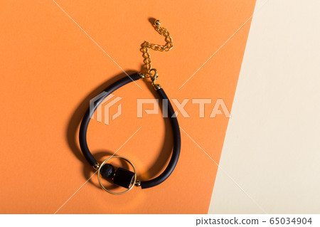 Women's Jewelry. Trendy jewelry on coloured background. Flat lay, top view. 65034904