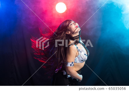 Spirituality dance. Beautiful sexy woman with luxury glossy eastern make-up dancing tribal fusion. Belly dance. Spirituality dance. Beautiful sexy woman with luxury glossy eastern make-up dancing tribal fusion. Belly dance. 65035056