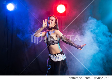 Spirituality dance. Beautiful sexy woman with luxury glossy eastern make-up dancing tribal fusion. Belly dance. Spirituality dance. Beautiful sexy woman with luxury glossy eastern make-up dancing tribal fusion. Belly dance. 65035058