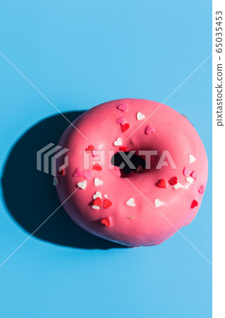Trendy sunlight. Doughnut on bright light blue turquoise background. Minimal summer concept. Pop art style. Pink donut. Trendy sunlight. Doughnut on bright light blue turquoise background. Minimal summer concept. Pop art style. Pink donut. 65035453