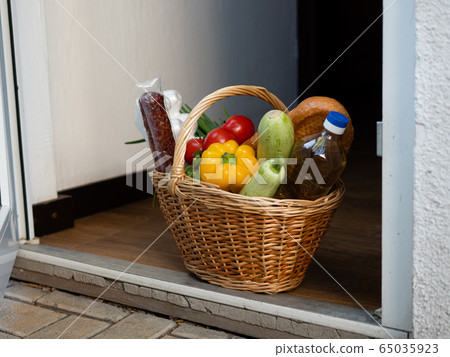 Contactless delivery. Apartment entrance with delivered basket. Epidemic Control Prevention measures of coronavirus Contactless delivery. Apartment entrance with delivered basket. Epidemic Control Prevention measures of coronavirus 65035923