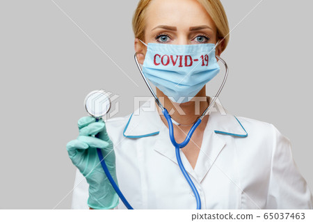 female doctor with stethoscope wearing protective mask and latex gloves over light grey background female doctor with stethoscope wearing protective mask and latex gloves over light grey background 65037463