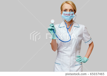 female doctor with stethoscope wearing protective mask and latex gloves over light grey background female doctor with stethoscope wearing protective mask and latex gloves over light grey background 65037465